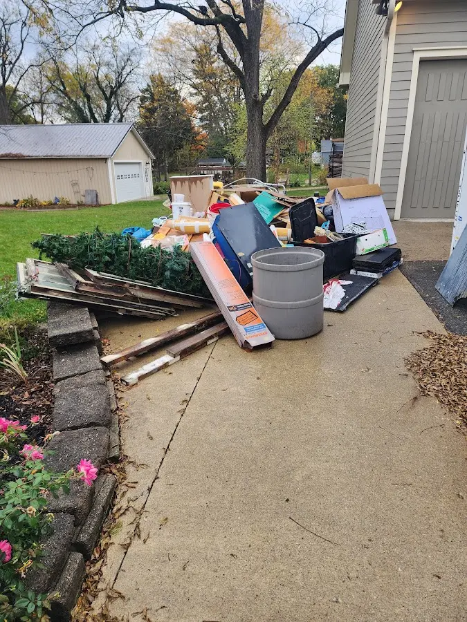 Dumpster being loaded with debris for 3 Yard Dumpster Rental in Almont